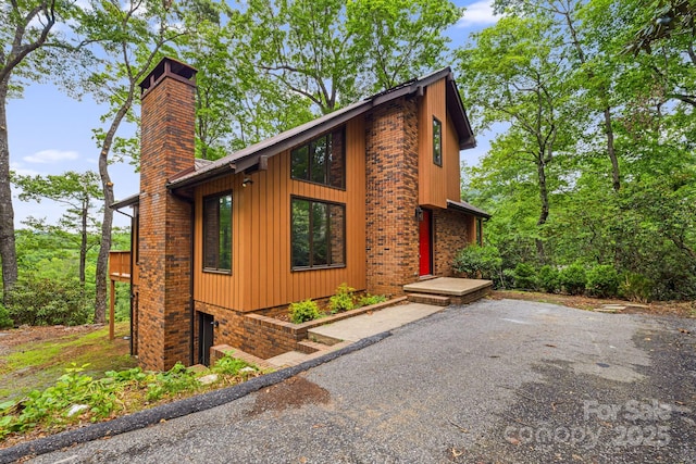 285 Fairway Loop Unit 7, Burnsville, NC 28714 - view of side of property featuring a chimney and a garage