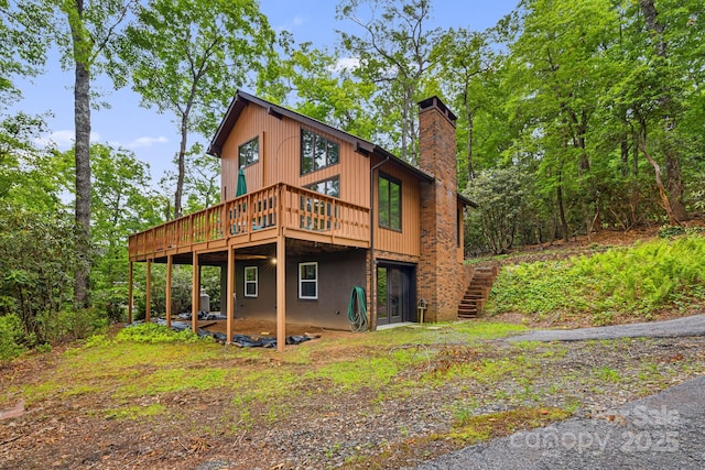 285 Fairway Loop Unit 7, Burnsville, NC 28714 - back of house featuring a chimney, stairs, and a deck