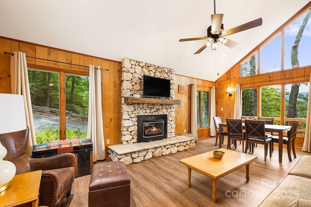 285 Fairway Loop Unit 7, Burnsville, NC 28714 - living room featuring wood walls, healthy amount of natural light, high vaulted ceiling, wood finished floors, and a ceiling fan