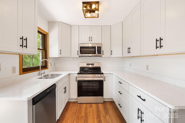 285 Fairway Loop Unit 7, Burnsville, NC 28714 - kitchen featuring stainless steel appliances, light wood finished floors, white cabinetry, and light countertops