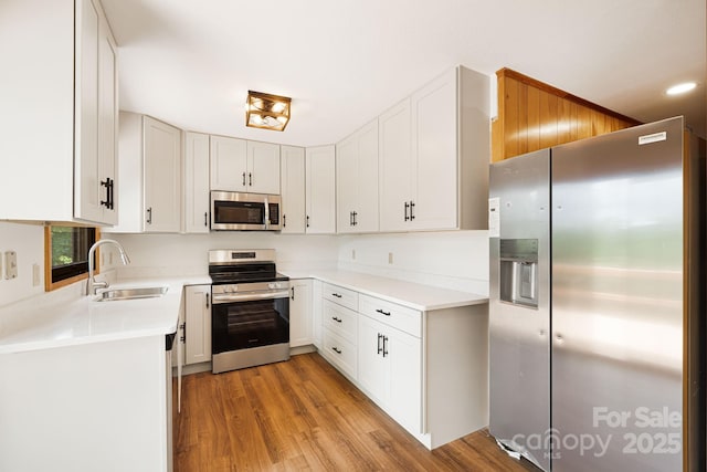285 Fairway Loop Unit 7, Burnsville, NC 28714 - kitchen with stainless steel appliances, light wood-style floors, light countertops, and white cabinets