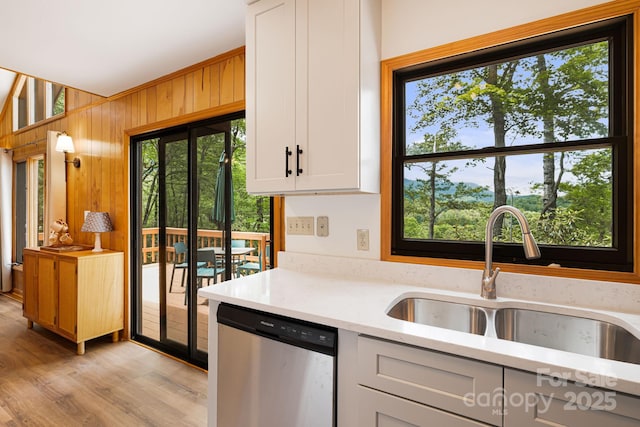 285 Fairway Loop Unit 7, Burnsville, NC 28714 - kitchen with dishwasher, healthy amount of natural light, white cabinets, wood walls, and light wood-type flooring