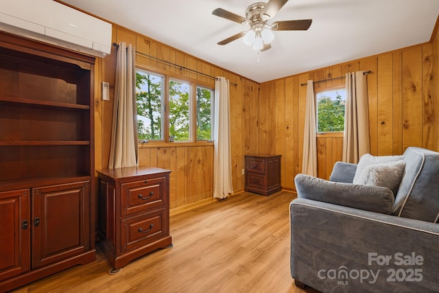285 Fairway Loop Unit 7, Burnsville, NC 28714 - sitting room featuring ceiling fan, light wood-type flooring, wooden walls, and an AC wall unit