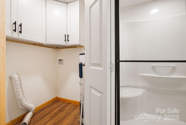 285 Fairway Loop Unit 7, Burnsville, NC 28714 - laundry area featuring cabinet space, wood finished floors, washer hookup, and water heater
