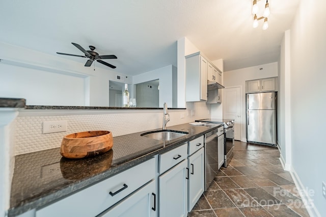 1315 E Blvd Unit 327, Charlotte, NC 28203 - kitchen with stainless steel appliances, stone tile flooring, tasteful backsplash, a ceiling fan, and dark stone counters