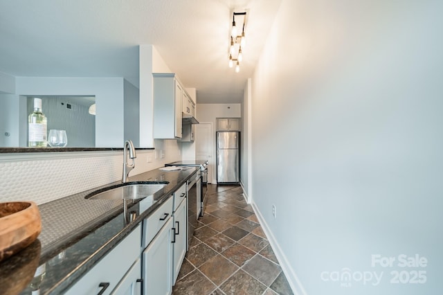 1315 E Blvd Unit 327, Charlotte, NC 28203 - kitchen with stainless steel appliances, stone tile flooring, tasteful backsplash, dark stone counters, and white cabinets