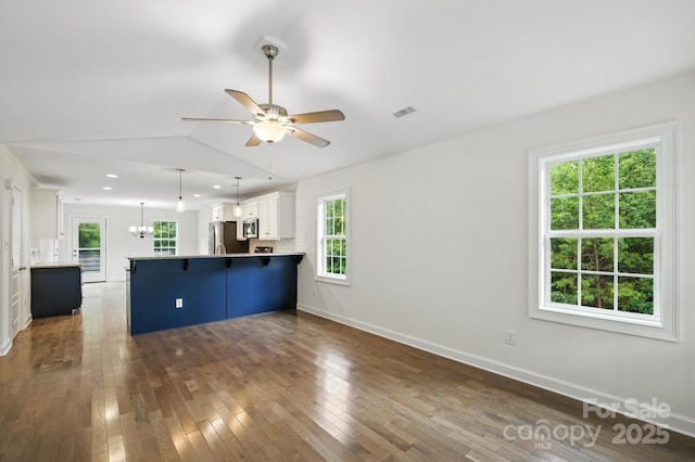 8782 Shepherd Ct, Hildebran, NC 28612 - kitchen with stainless steel appliances, a peninsula, a kitchen breakfast bar, white cabinetry, and a ceiling fan