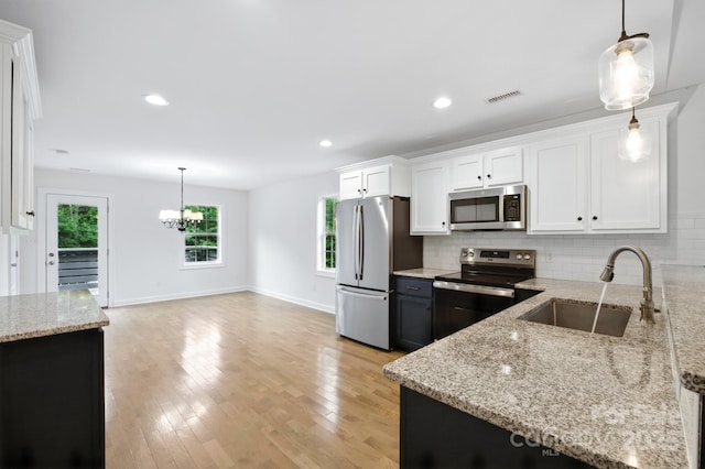 8782 Shepherd Ct, Hildebran, NC 28612 - kitchen with stainless steel appliances, tasteful backsplash, light stone counters, white cabinetry, and recessed lighting