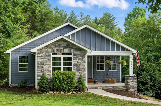 8782 Shepherd Ct, Hildebran, NC 28612 - view of front of house featuring stone siding, board and batten siding, and a front lawn