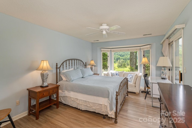 103 Golfside Dr, Flat Rock, NC 28731 - bedroom featuring light wood-type flooring, a ceiling fan, and a textured ceiling