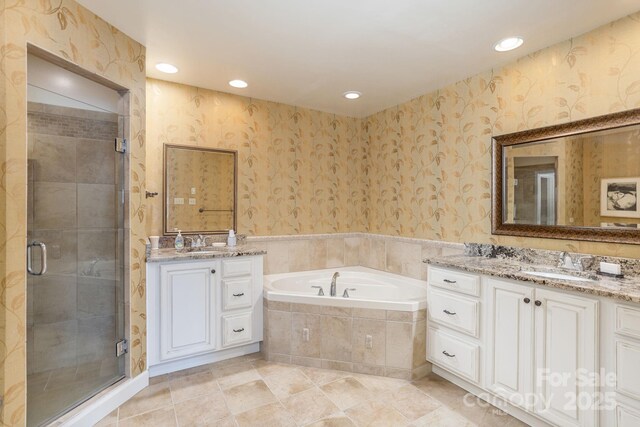 103 Golfside Dr, Flat Rock, NC 28731 - full bathroom featuring wallpapered walls, two vanities, a bath, a stall shower, and recessed lighting