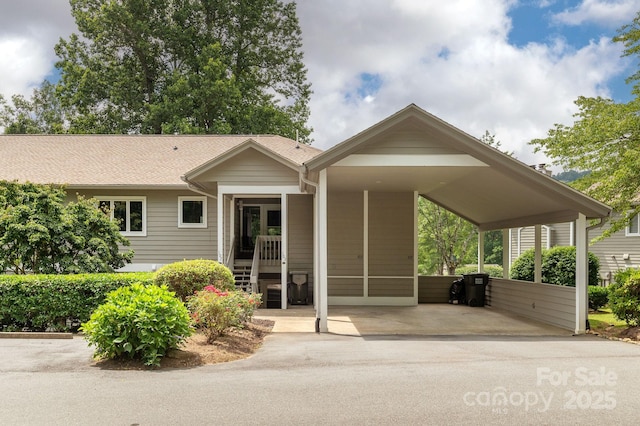 103 Golfside Dr, Flat Rock, NC 28731 - view of front of house with concrete driveway, a carport, and a shingled roof