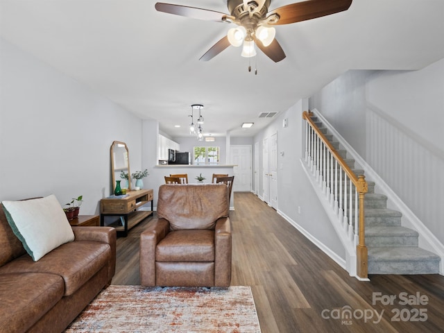 3414 Broadwick St, Charlotte, NC 28213 - living area with dark wood-style floors, stairs, ceiling fan, and a chandelier