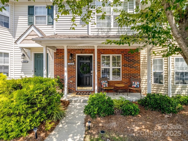 3414 Broadwick St, Charlotte, NC 28213 - doorway to property featuring a porch and brick siding
