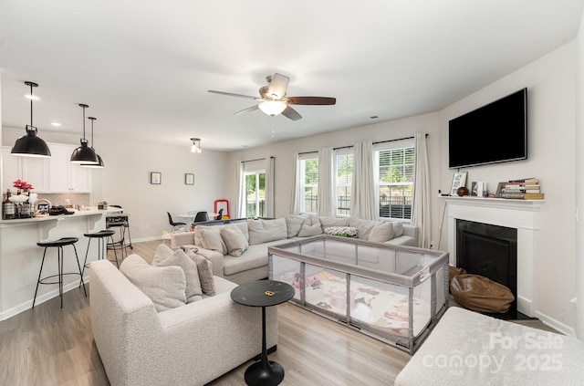 15636 Oleander Dr, Charlotte, NC 28278 - living area with a fireplace with flush hearth, ceiling fan, light wood-style flooring, and recessed lighting