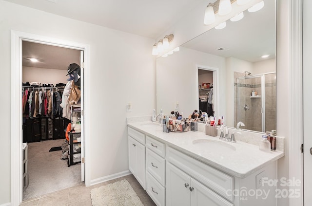 15636 Oleander Dr, Charlotte, NC 28278 - bathroom with double vanity, a walk in closet, a stall shower, and tile patterned flooring