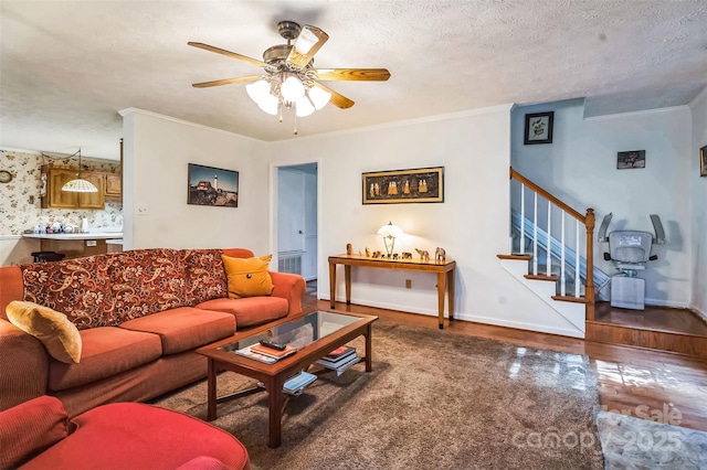 815 La Quinta Ln, Hope Mills, NC 28348 - living area with a ceiling fan, wood finished floors, stairs, ornamental molding, and a textured ceiling