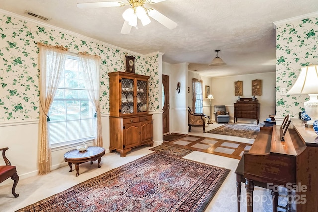 815 La Quinta Ln, Hope Mills, NC 28348 - foyer entrance featuring wallpapered walls, ornamental molding, a ceiling fan, wainscoting, and a textured ceiling
