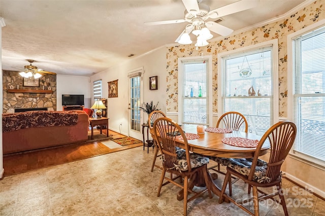 815 La Quinta Ln, Hope Mills, NC 28348 - dining area with ceiling fan, crown molding, and a fireplace