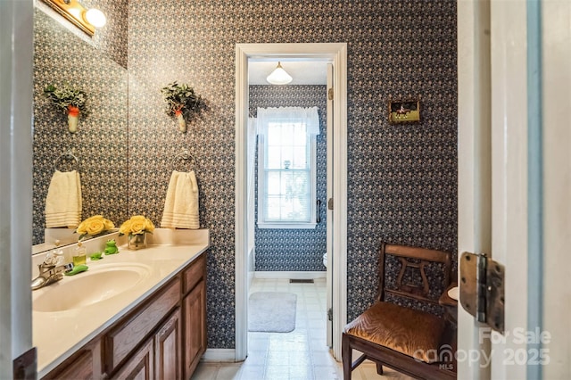815 La Quinta Ln, Hope Mills, NC 28348 - bathroom with vanity, wallpapered walls, and tile patterned flooring