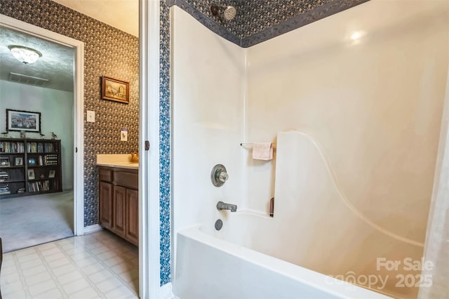 815 La Quinta Ln, Hope Mills, NC 28348 - bathroom with shower / washtub combination, vanity, tile patterned floors, and wallpapered walls