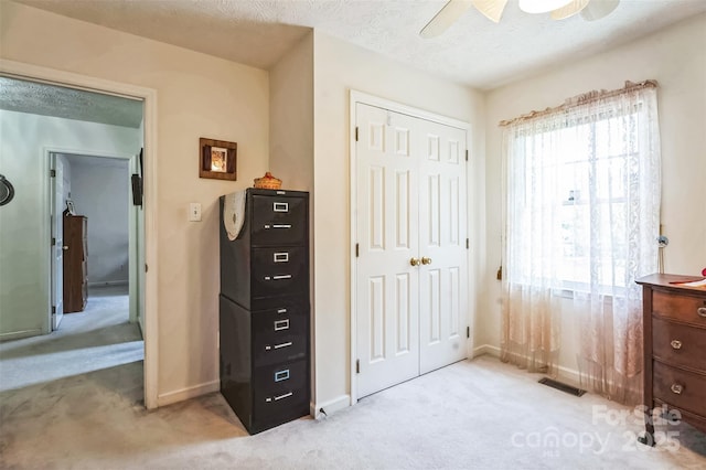 815 La Quinta Ln, Hope Mills, NC 28348 - bedroom with light colored carpet, a closet, a ceiling fan, and a textured ceiling