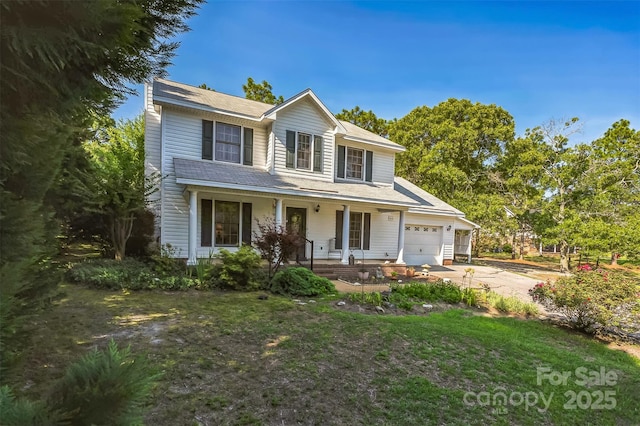 815 La Quinta Ln, Hope Mills, NC 28348 - traditional-style house featuring a porch, an attached garage, driveway, and roof with shingles