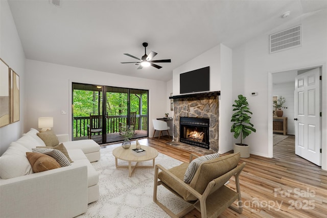 45B Mountain Vw, Villas, Franklin, NC 28734 - living room with a ceiling fan, wood finished floors, a stone fireplace, and high vaulted ceiling