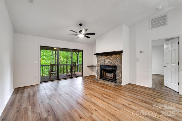45B Mountain Vw, Villas, Franklin, NC 28734 - unfurnished living room featuring a ceiling fan, wood finished floors, a fireplace, and high vaulted ceiling