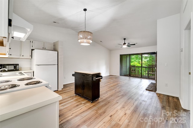 45B Mountain Vw, Villas, Franklin, NC 28734 - kitchen with white appliances, light countertops, vaulted ceiling, light wood finished floors, and pendant lighting