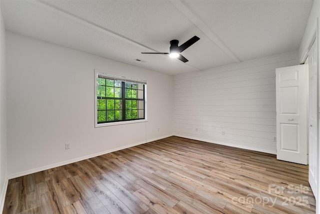 45B Mountain Vw, Villas, Franklin, NC 28734 - empty room featuring ceiling fan, wood finished floors, and wooden walls