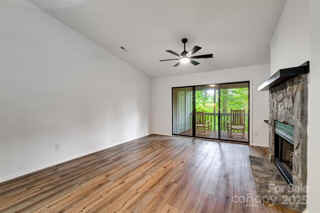 45B Mountain Vw, Villas, Franklin, NC 28734 - unfurnished living room featuring hardwood / wood-style flooring, a fireplace, vaulted ceiling, and a ceiling fan