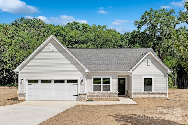 4472 Pebblebrook Cir SW, Concord, NC 28027 - view of front of home featuring concrete driveway, roof with shingles, brick siding, and a garage