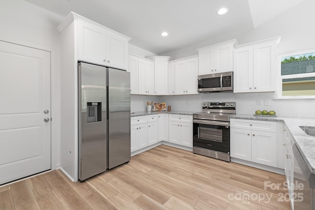 4472 Pebblebrook Cir SW, Concord, NC 28027 - kitchen featuring stainless steel appliances, backsplash, white cabinets, light stone counters, and recessed lighting