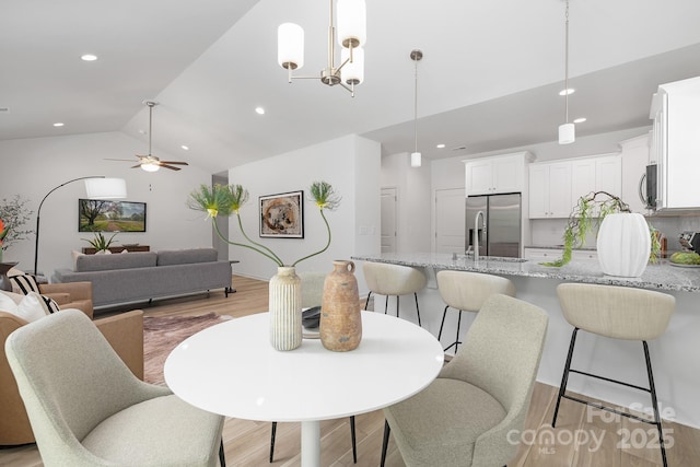 4472 Pebblebrook Cir SW, Concord, NC 28027 - dining space featuring light wood-style floors, high vaulted ceiling, recessed lighting, and ceiling fan