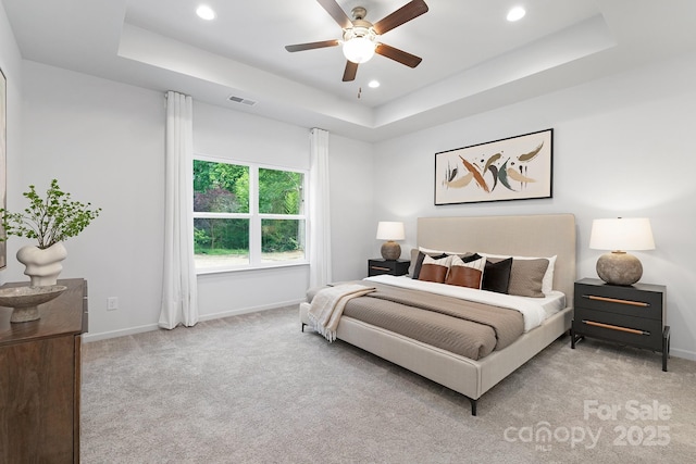4472 Pebblebrook Cir SW, Concord, NC 28027 - carpeted bedroom with a tray ceiling, recessed lighting, and ceiling fan