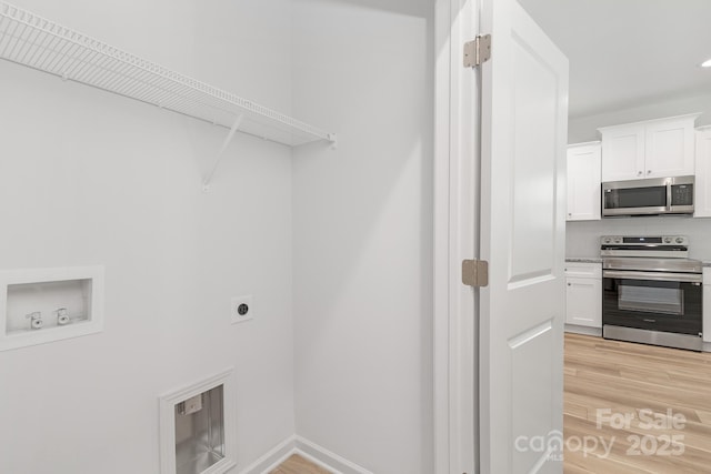 4472 Pebblebrook Cir SW, Concord, NC 28027 - laundry room with washer hookup, light wood-style flooring, and hookup for an electric dryer