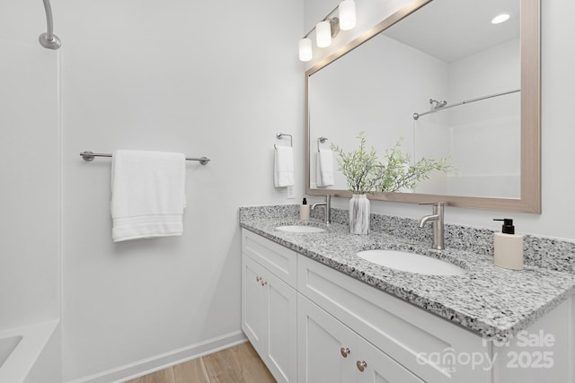 4472 Pebblebrook Cir SW, Concord, NC 28027 - full bath with double vanity, wood finished floors, and a shower