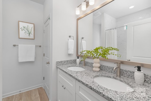4472 Pebblebrook Cir SW, Concord, NC 28027 - full bath featuring double vanity, wood finished floors, a shower with curtain, and recessed lighting
