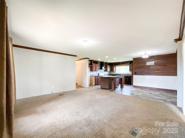 5321 State Line Rd, Marshville, NC 28103 - unfurnished living room featuring light carpet, wooden walls, and recessed lighting