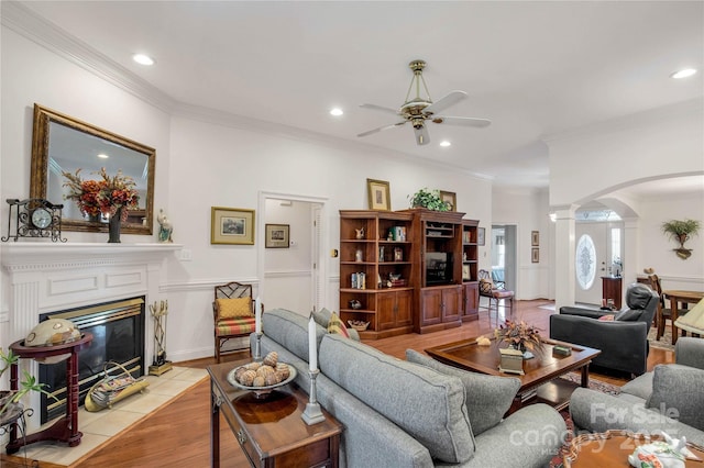 511 Birmingham Ct, Rock Hill, SC 29732 - living area with arched walkways, a ceiling fan, crown molding, a tiled fireplace, and recessed lighting