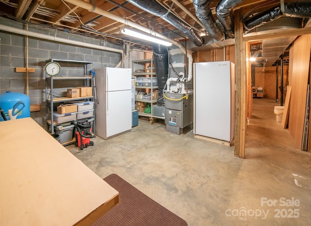 1465 Ohennesy Ln Unit 12, 13, 14, 15, Lenoir, NC 28645 - unfinished basement featuring freestanding refrigerator, concrete block wall, heating unit, and a water pressure tank