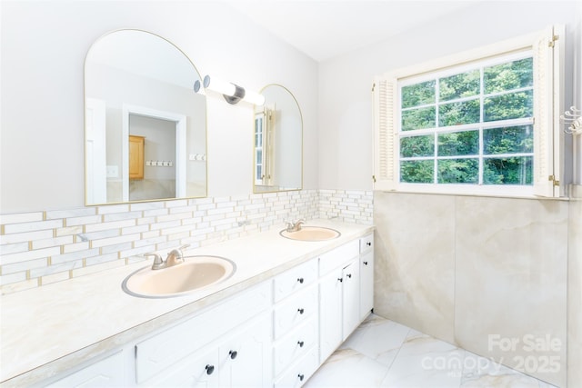 1728 Colony Rd, Salisbury, NC 28144 - bathroom with marble look tiles, double vanity, and tasteful backsplash