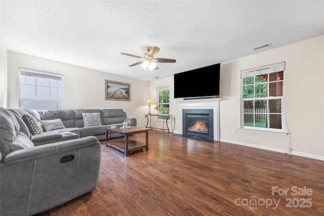 241 Chestnut Ave, Tega Cay, SC 29708 - living room featuring wood finished floors, ceiling fan, a fireplace with flush hearth, and a textured ceiling