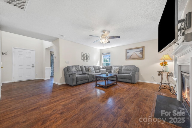 241 Chestnut Ave, Tega Cay, SC 29708 - living room featuring a ceiling fan, wood finished floors, a fireplace with flush hearth, and a textured ceiling