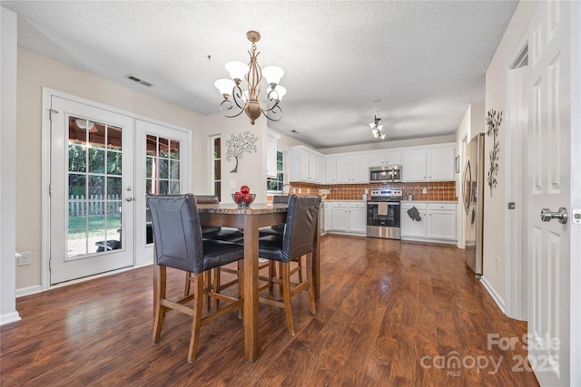241 Chestnut Ave, Tega Cay, SC 29708 - dining space with a chandelier, dark wood-style floors, french doors, and a textured ceiling
