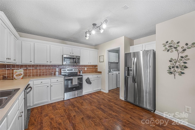 241 Chestnut Ave, Tega Cay, SC 29708 - kitchen with stainless steel appliances, independent washer and dryer, tasteful backsplash, white cabinetry, and dark wood finished floors