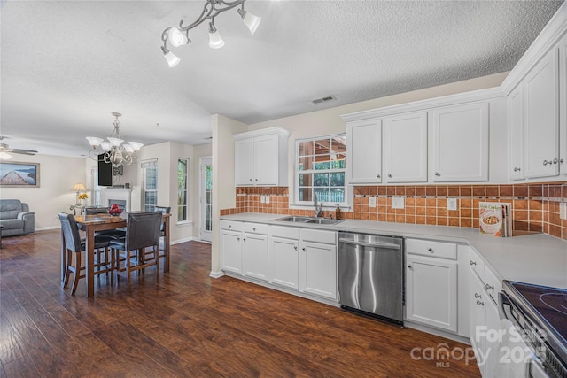 241 Chestnut Ave, Tega Cay, SC 29708 - kitchen with stainless steel appliances, a chandelier, a textured ceiling, light countertops, and dark wood-type flooring