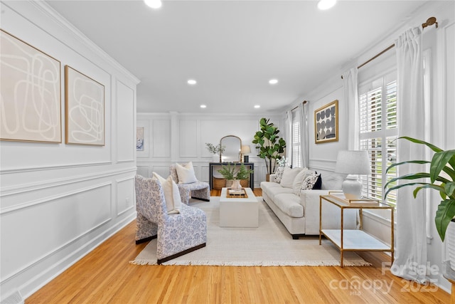 1024 Regency Dr, Charlotte, NC 28211 - living room featuring a decorative wall, recessed lighting, wood finished floors, and crown molding