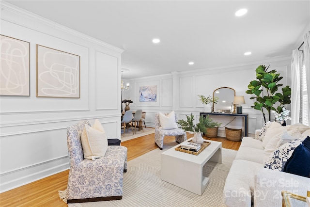 1024 Regency Dr, Charlotte, NC 28211 - living room with a decorative wall, light wood finished floors, ornamental molding, recessed lighting, and a chandelier